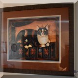 A25. Framed cat print.